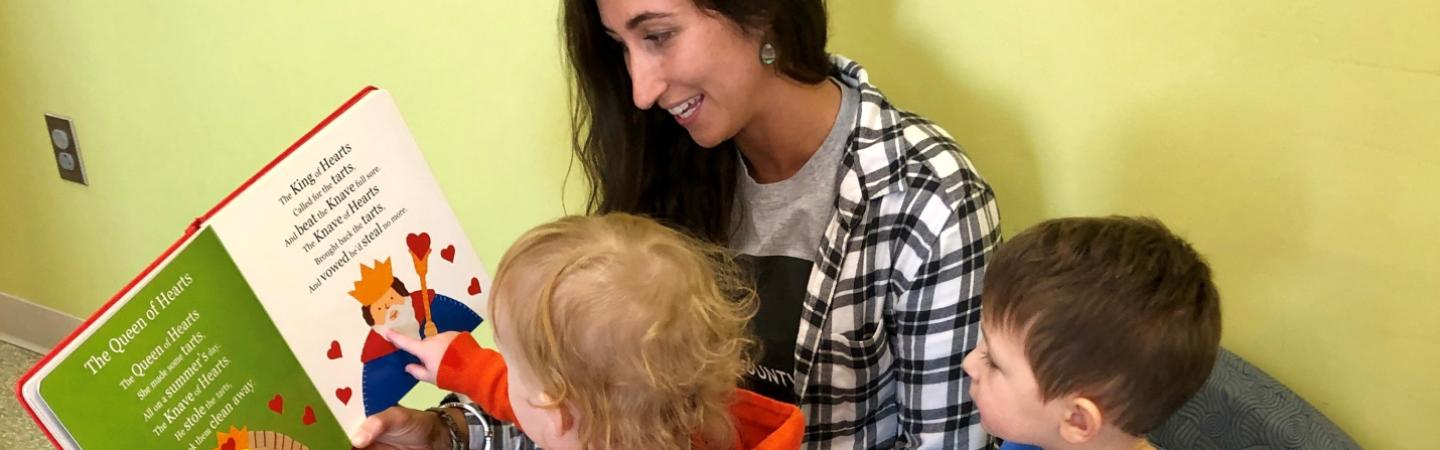 Y staff member reads to children during Parent's Night Out at our Northwest Y Branch